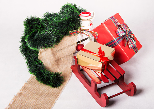 Sleds and Christmas gifts on white background