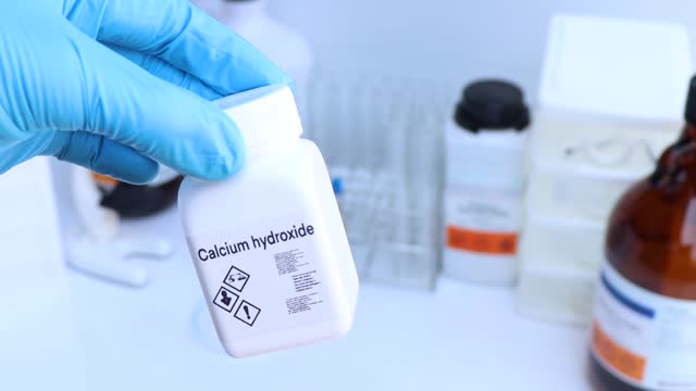 Calcium hydroxide in bottle , chemical in the laboratory and industry