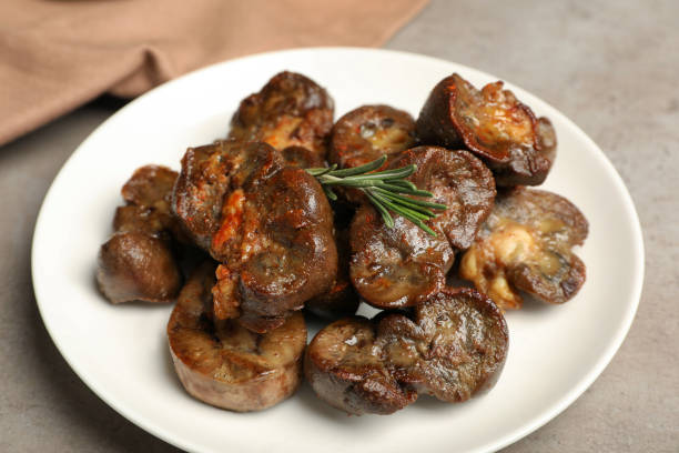 istock Plate with delicious kidneys and rosemary on light table, closeup 1451733771