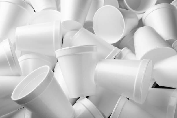 istock Heap of white styrofoam cups as background, closeup 1451734102