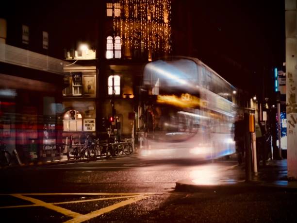 At the light crossing by Glasgow  train station, captured during the Christmas rush on the 22nd December 2022. Buses passing and people crossing the street after dark