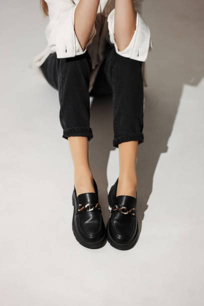 black loafers on female legs close-up fashion casual shoes for women shoe polish photos stock pictures, royalty-free photos & images