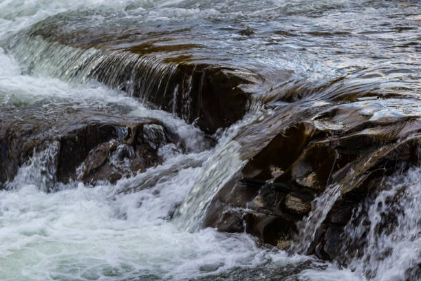istock The stream of water flowing over rocks.Image close-up 1451743191