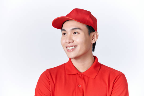 istock Young handsome delivery man wearing cap standing over isolated red background with serious expression on face 1451745203