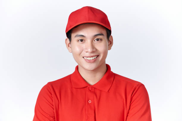 istock Young handsome man wearing delivery courier uniform looking away to side with smile on face 1451745228