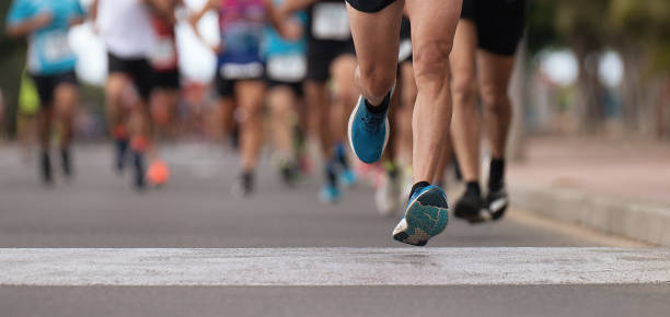 istock Marathon runners running on city road 1451748335