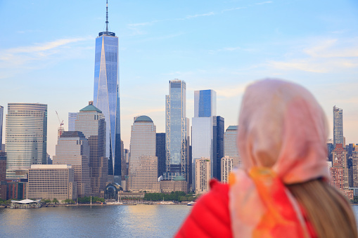 Pretty  active women Long blonde hair enjoying  in  Panorama of New York City skyline Lower Manhattan and the Freedom Tower Panoramic. Focus on bacgrounds.