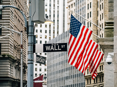 A photograph of the United Stripes Flag with the Empire State Building in the background