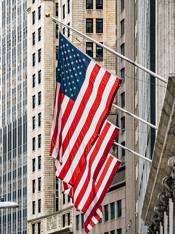 USA flags in Manhattan. Wall street district in New York City.