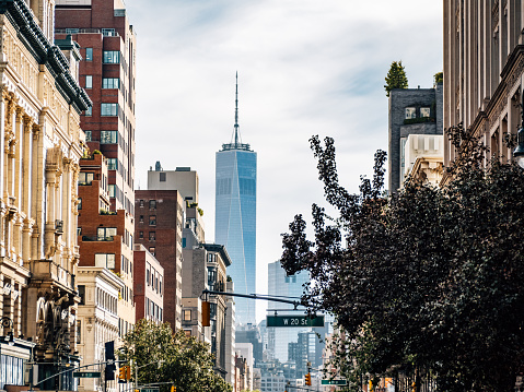A street of Manhattan with Freedom Tower in the background. 6th Avenue in New York City.