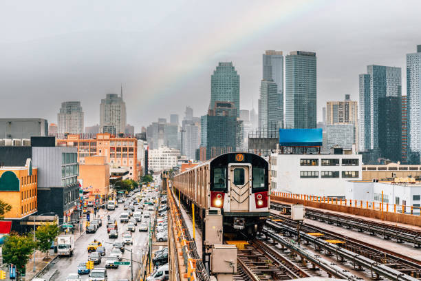 New York City subway train is approaching an elevated subway station in Queens