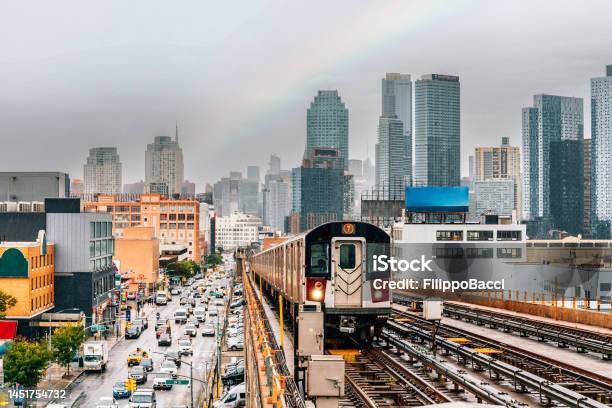 New York City Subway Train Is Approaching An Elevated Subway Station In Queens Stock Photo - Download Image Now