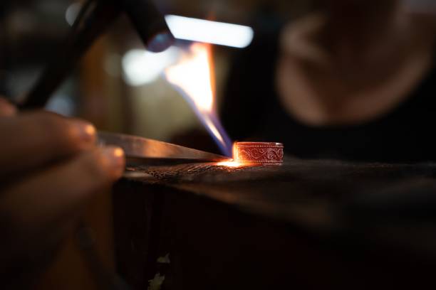 istock Closeup of forging a silver ring at the smith 1451758906