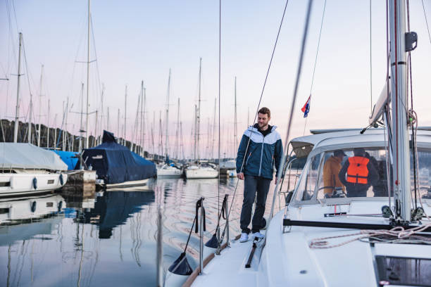 istock Sailor Walking Towards The Pier With The Sailboat At Its Destination 1451761814