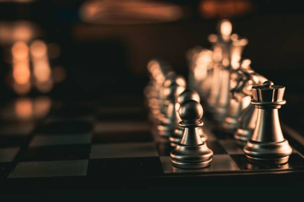 istock Close-up shot of silver chess pieces on a chessboard 1451763118