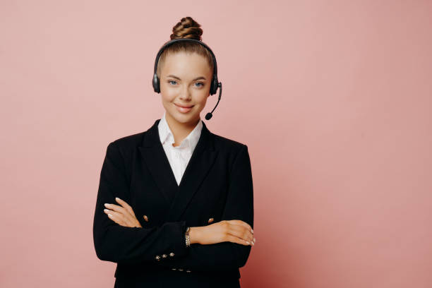 istock Happy female support center agent in dark suit posing in studio 1451768944