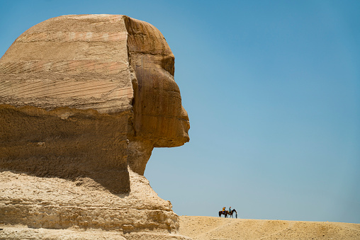 The Sphinx in Egyptian Gize Pyramid area and two people riding horses