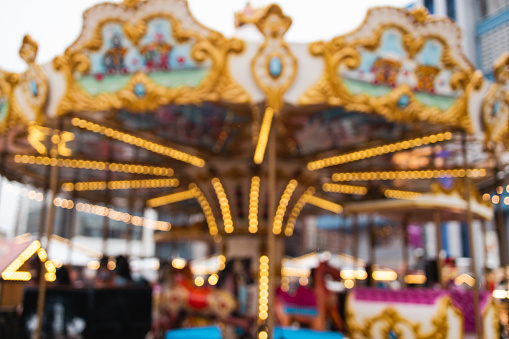Christmas fair, traditional fair carousel with lights blurred background