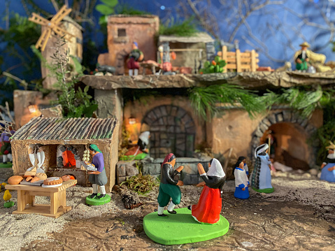 Figures of a traditional nativity scene: shepherd in a bakery, shepherd dancing