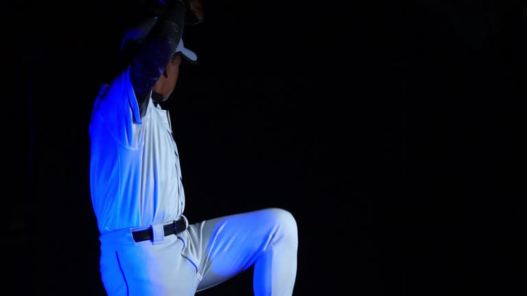 A baseball player pitcher with his baseball and baseball gloves