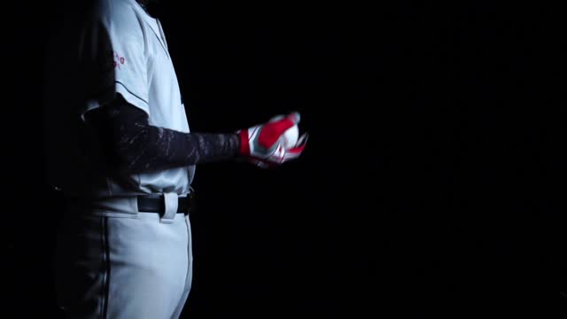 A baseball player pitcher with his baseball and baseball gloves
