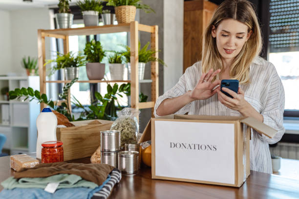 istock Young woman packing donations 1451795794