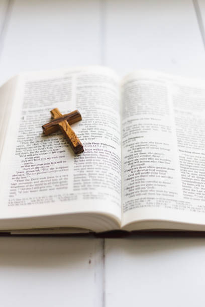 istock Wooden cross on open holy bible 1451797339