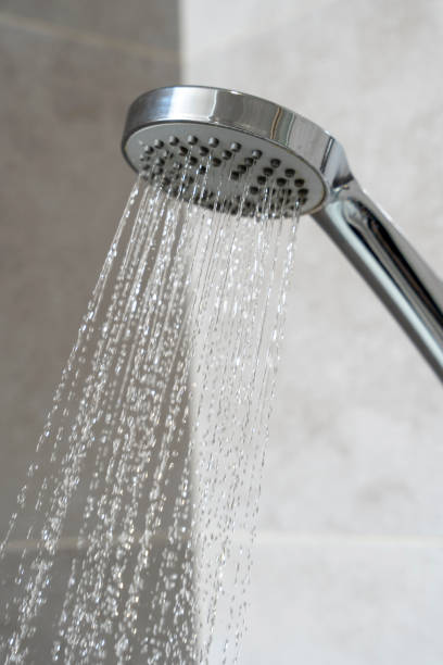 istock water pours from the shower head. shower-bath. Close up 1451798577