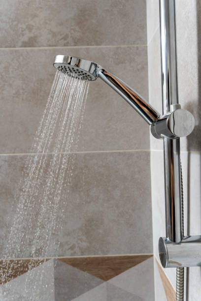 istock water pours from the shower head. shower-bath. Close up 1451798582