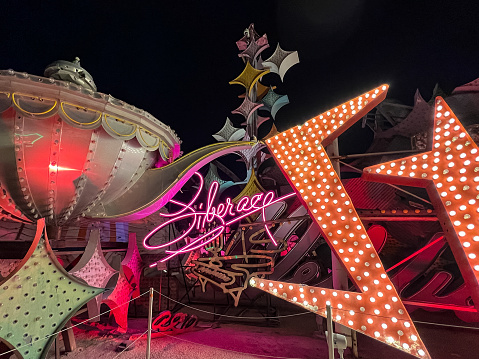 Las Vegas, NV, USA - November 4, 2022: Neon signs lighted at night at The Neon Museum in Las Vegas, Nevada, United States, which features signs from old casinos and other businesses displayed outdoors on 2.62 acres.