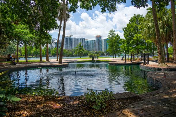 istock Beautiful park with a small bridge over an artificial lake 1451803826