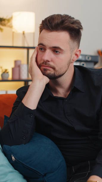 istock Young guy at home suffers from unfair situation problem, break up, depressed, feeling bad, burnout 1451804918