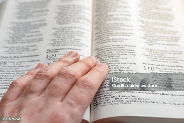 Hand Resting On Pages Of Holy Bible Stock Photo - Download Image Now - Bible, Book, Christianity