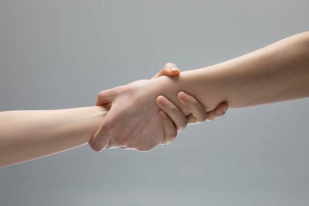 istock Beautiful shot of two hands holding each other 1451810500