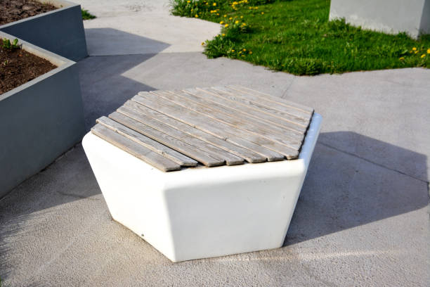 istock white plastic and wooden bench isolated on concrete background, close-up 1451813770
