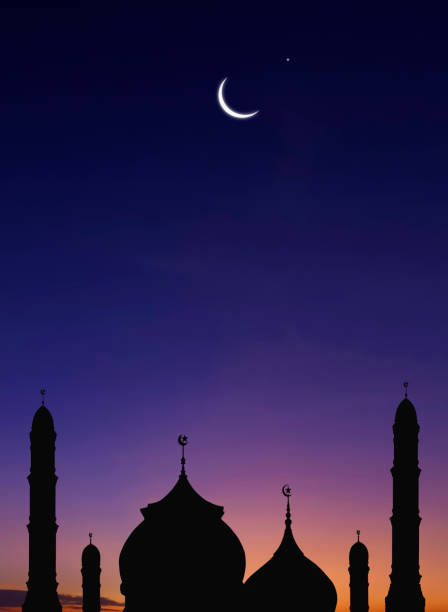 istock Silhouette of Mosques Dome and Crescent Moon on dark blue Twilight sky Background in vertical frame 1451816722