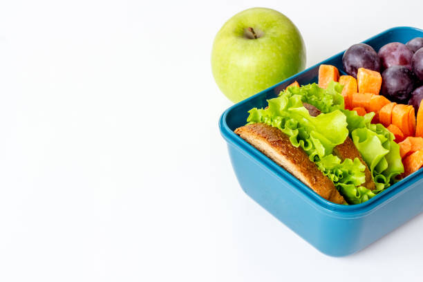 istock Lunch box set with bread fruits and vegetables, close up 1451818217