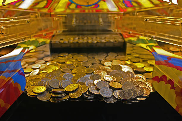 tenpenny falls A 10 penny falls arcade machine with focus on the line about to fall. Weston Super Mare, UK. british falling pounds stock pictures, royalty-free photos & images