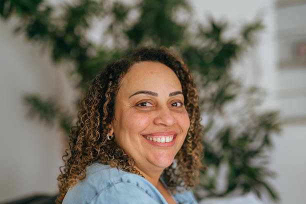 istock Smiling woman with curly hair 1451824188