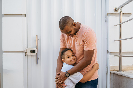 Son with down syndrome hugging his father