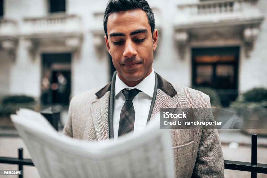 business man reading a newspaper on the street Newspaper Stock Photo