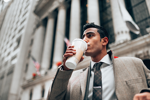business man drinking a cup of coffee outdoor