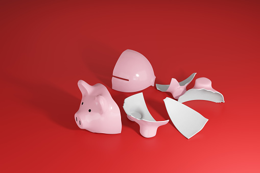 Broken pink piggy bank on red background. Illustration of the collapse of economy and crisis of retirement pension funds