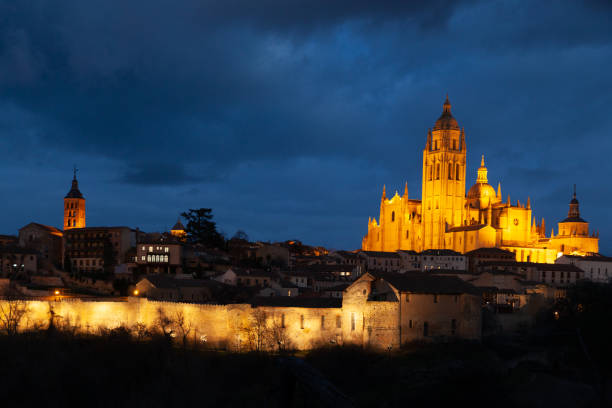 Segovia, Spain - 4 January 2022: Panoramic view of Segovia with the towers of cathedral and dramatic sky at dusk