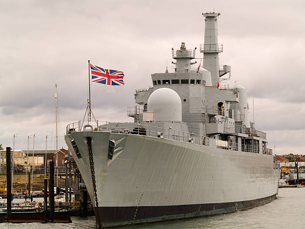 Photograph of a British naval ship at port British war ship tied alongside. warship photos stock pictures, royalty-free photos & images