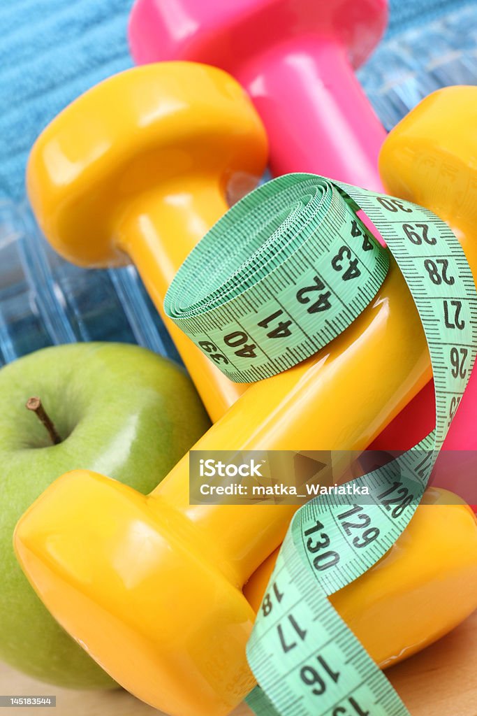 sports equipment sports equipment - dumbbells water and green apple Activity Stock Photo