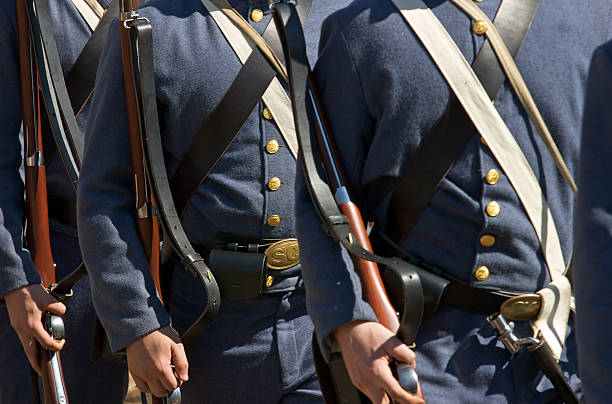 US Civil War re-enactors Civil War re-enactors march in formation carrying period (1860s) equipment and muskets. reenactment stock pictures, royalty-free photos & images