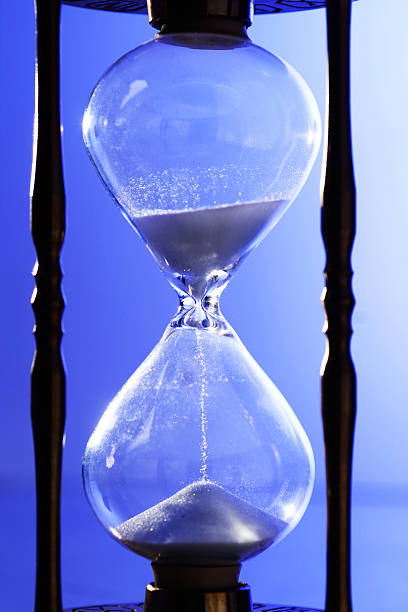 Hourglass closeup on blue stock photo