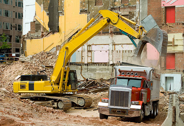 Front End Loader Dropping Demolition Scrap Materials Into Dump Truck stock photo