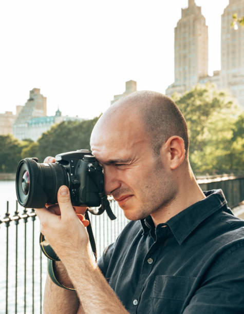 istock photographer take a pictures in central park 1451844061